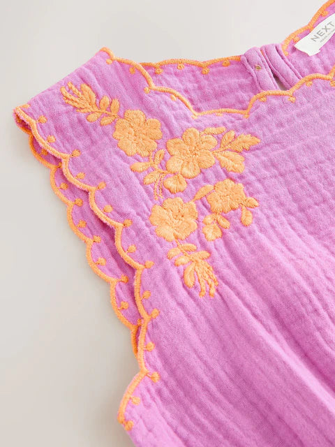 Combinaison enfant violette avec pompons décoratifs (3-16 ans)