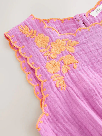 Combinaison enfant violette avec pompons décoratifs (3-16 ans)
